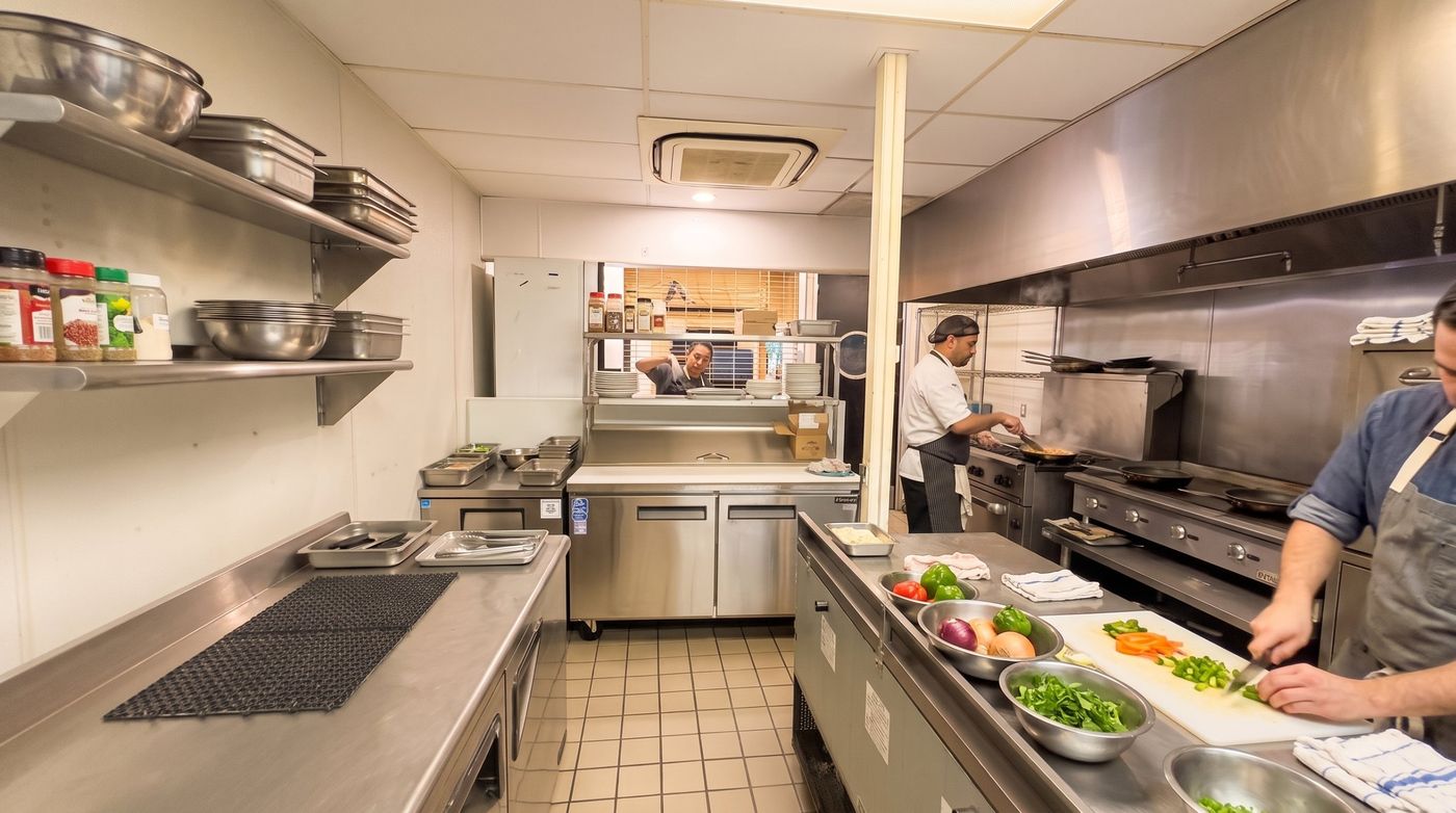 Cooks prepping and cooking on a commercial kitchen line